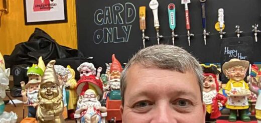 Man in front of garden gnomes in a pub